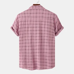 Rear view of a men's pink short-sleeved plaid shirt displayed on a stylish wooden hanger