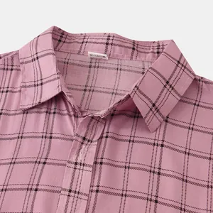 Close-up macro view of the buttoned collar on a pink checkered slim-fit men's shirt