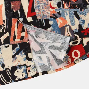 Close-up of vibrant graffiti-style graphic print on men's summer shirt fabric.