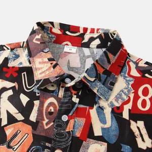 Close-up detail of men's casual shirt featuring bold abstract alphabet print and collar