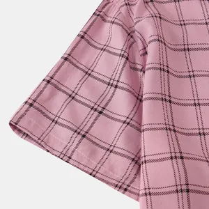 Close-up detail of pink checkered men's short sleeve shirt showing fabric texture and seam