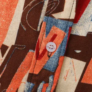 Close-up macro detail of men's casual floral shirt fabric showing linen texture and button