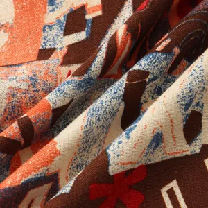 Macro detail of breathable linen-like fabric with vibrant geometric tribal print.