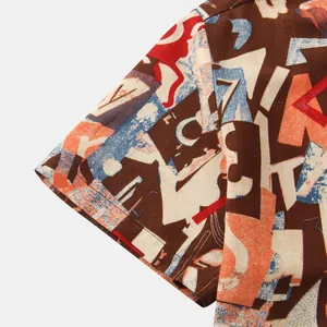 Detailed view of short sleeve shirt featuring colorful abstract geometric print