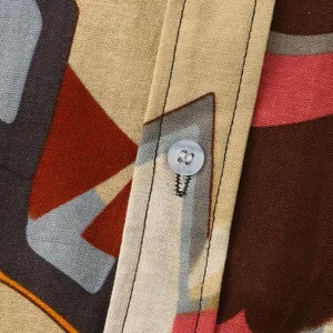 Close-up of a patterned men's casual shirt showing the fabric texture and button detail