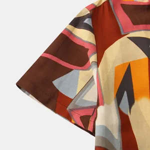 Detailed view of men's short sleeve shirt featuring colorful abstract geometric patterns