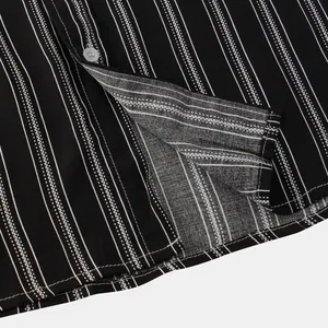 Macro detail of men's black and white striped shirt showing fine fabric texture and button