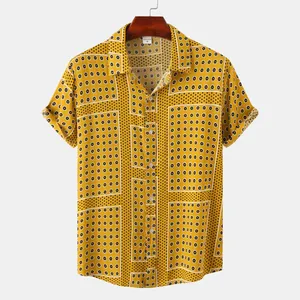 Detailed view of men's short sleeve button-up shirt with yellow floral tile pattern