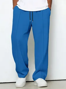 Detail of blue waffle knit texture on men's straight leg trousers with drawstrings