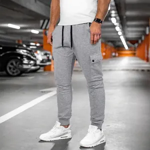 Men's light gray multi-pocket cargo sweatpants with drawstring waist and ribbed cuffs