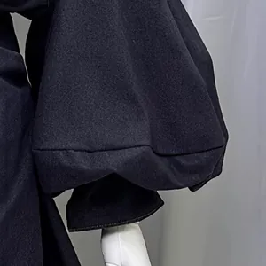 Elegant black denim dress featuring vintage puff lantern sleeves and a stylish tie-waist design