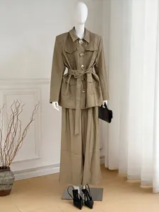 Detailed view of early autumn khaki suit set with belted jacket and wide-leg trousers