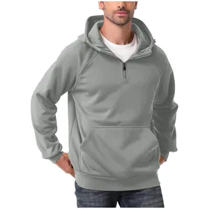 Close-up detail of men's heavyweight gray half-zip hoodie featuring a front kangaroo pocket