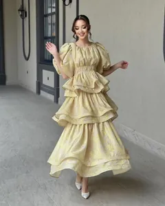 Elegant yellow floral tiered ruffled dress with puff sleeves and layered skirt details