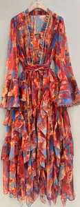 Close-up of the ruffled layers and rhinestone details on this floral printed dress.