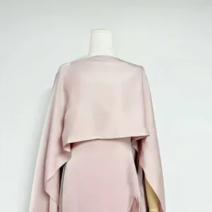 Detail of pink acetate satin dress featuring delicate fringe and matching shrug