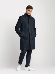 Professional full length shot of a men's navy mid-length minimalist windbreaker jacket