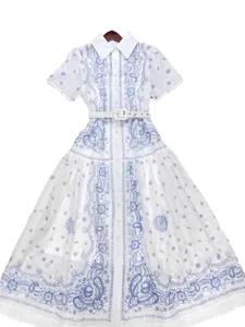 Elegant white vintage-style shirt dress with blue paisley patterns and a matching belt