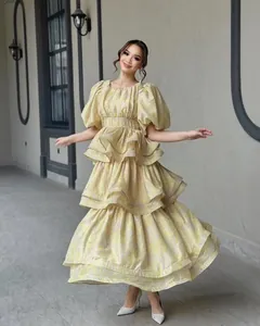 Full-length view of tiered floral print ruffled dress with puff sleeves on model