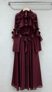 Detailed view of burgundy long sleeve dress featuring elegant ruffle layers and lace