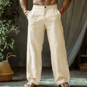 Detail of men's beige linen straight-leg beach trousers with button closure and pockets