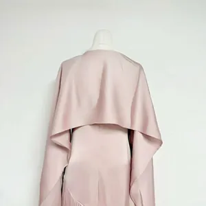 Back detail of pink acetate dress with matching capelet showing elegant satin sheen texture.