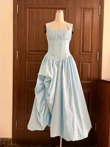 Elegant light blue halter dress with fishbone corset waist and irregular pleated skirt.