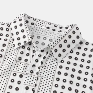 Detailed close-up view of a white patchwork shirt with floral and polka dot patterns.