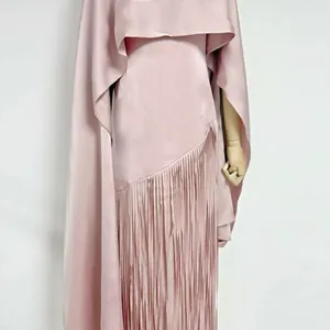 Detail view of pink satin acetate dress with elegant long fringe and matching shrug