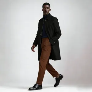 Full view of black mid-length men's trench coat styled with brown trousers and dark shoes