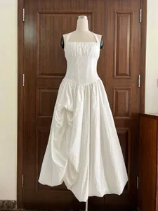 Detailed view of the white French romantic halter dress featuring a pleated bodice and corset waist