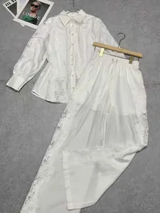 Elegant white lace shirt and wide-leg pants two-piece set with intricate hollow details.