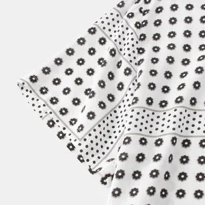 Close-up of short sleeve cuff on men's white shirt with floral and polka dot stripes