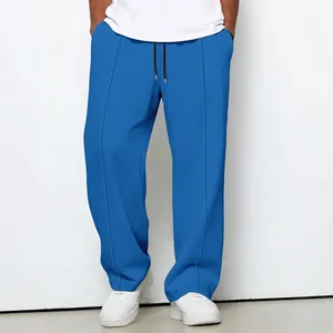 Relaxed fit men's blue waffle texture drawstring trousers featuring a straight-leg design