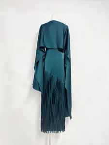 Back view of teal acetate satin dress with long fringe and matching shrug cape