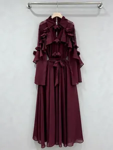 Elegant maroon long-sleeved dress featuring layered ruffles, belt, and lace details.