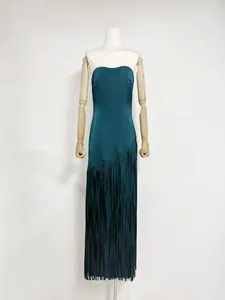 Detailed view of dark teal acetate dress featuring long diagonal fringe tassels