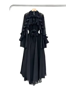 Elegant black maxi dress with layered ruffles, lace sleeves, and a tie waist belt.