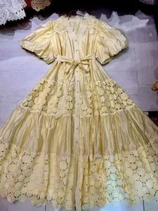 Detail view of a French vintage yellow lace maxi dress with elegant puff sleeves