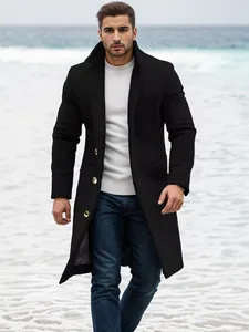 Elegant men's mid-length black wool overcoat shown in a stylish outdoor beach setting