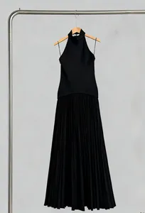 Vue détaillée d'une robe longue noire à col licou avec jupe plissée élégante.