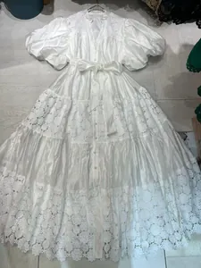 Full view flat lay of elegant French white lace embroidered maxi dress with puff sleeves