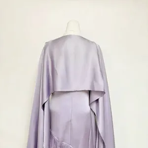 Close-up back view of elegant lavender acetate satin dress with shawl and fringe