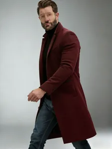 Detailed side view of a stylish burgundy mid-length wool coat for men in autumn