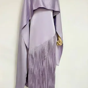 Detail of elegant purple acetate satin dress with long fringe and matching cape