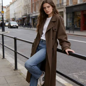 Outdoor street style photography of a woman wearing an elegant long brown wool coat