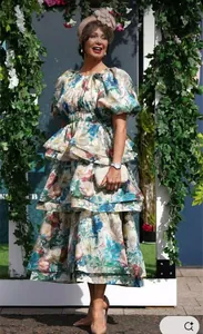 Detail of elegant floral tiered midi dress with puff sleeves in garden setting