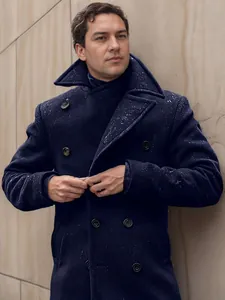 Close-up of stylish navy blue double-breasted wool pea coat with large buttons