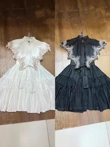 Stylish ruffle A-line dress with floral embroidery and tie waist in black and white colors