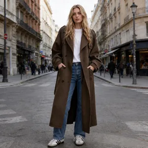 Full-length view of an elegant brown wool coat styled with blue jeans on a city street